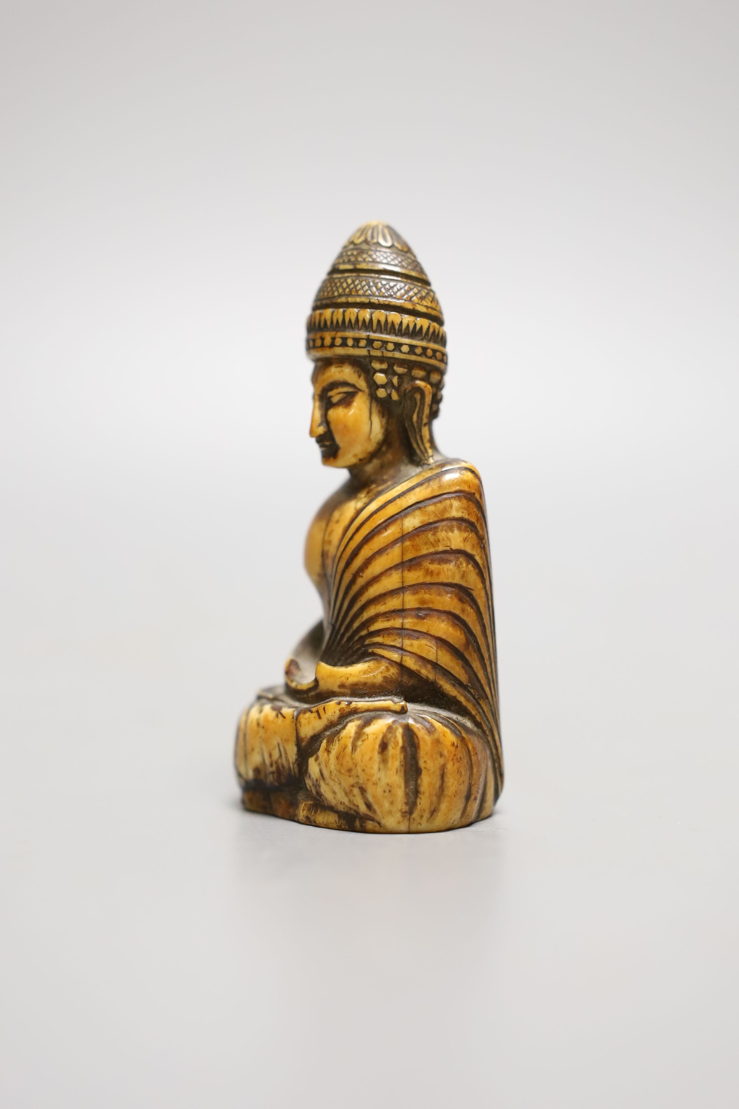 A Thai ivory buddha, probably 8th / 9th century, 9cms high.